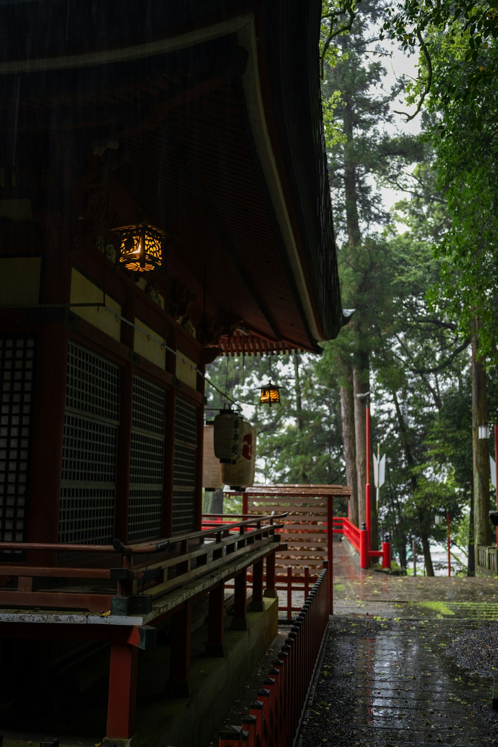 a red and white building sitting next to a forest