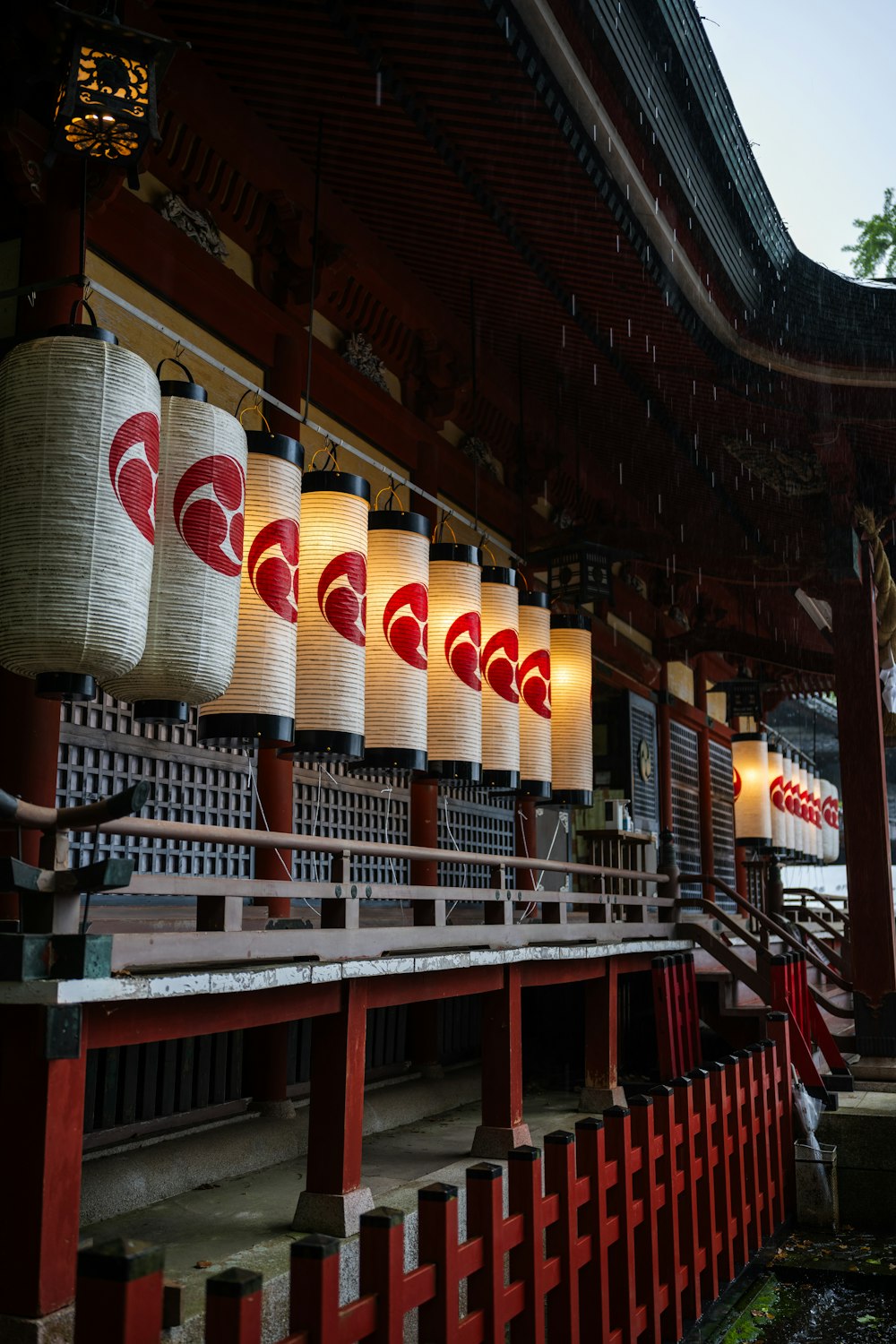 a row of lanterns hanging from the side of a building