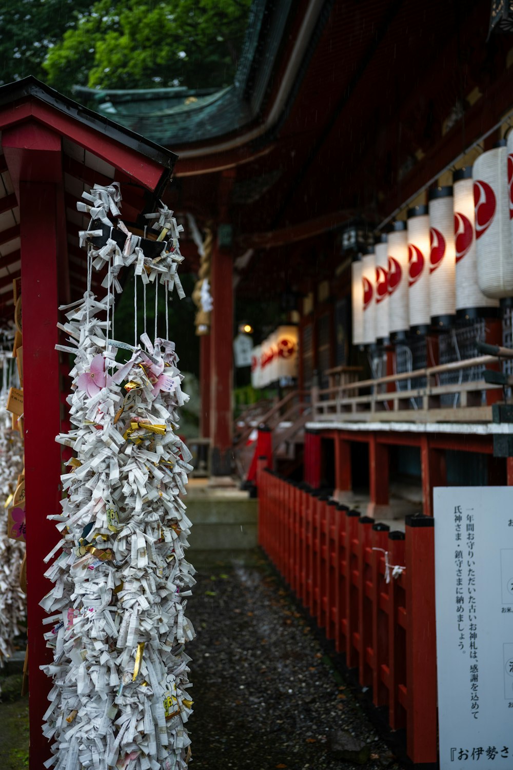 a bunch of papers hanging from a red pole