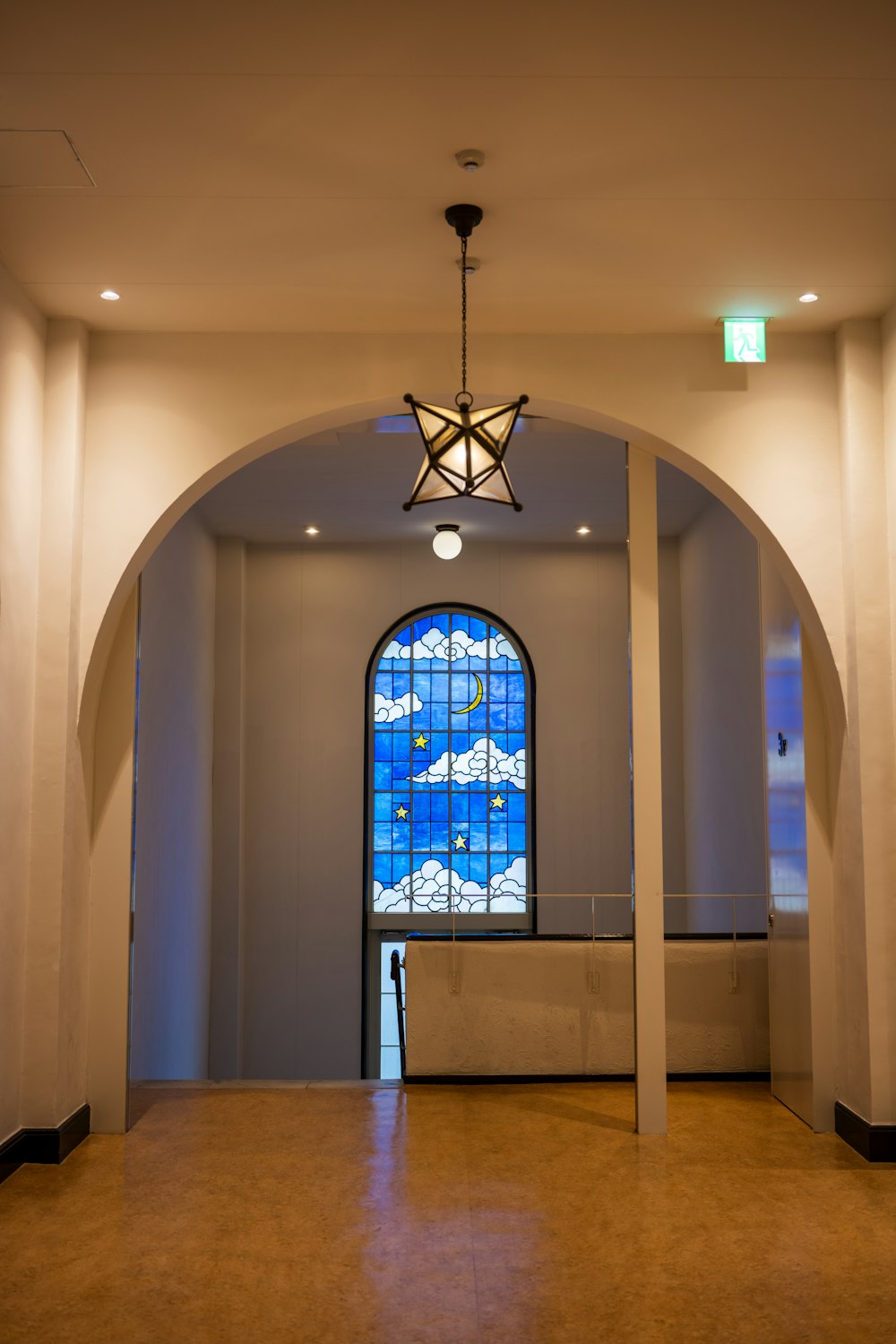 a large room with a stained glass window