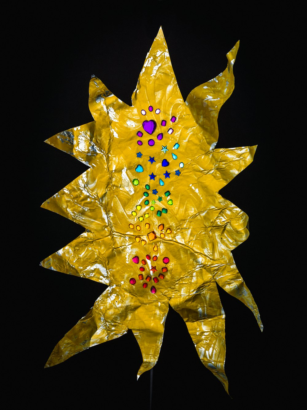 a yellow sunflower made out of plastic wrap