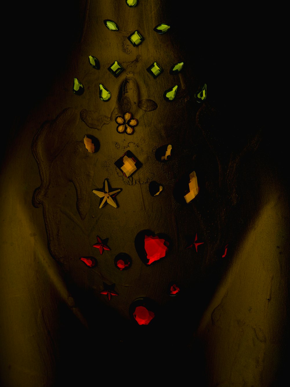 a person holding a lit up vase in the dark
