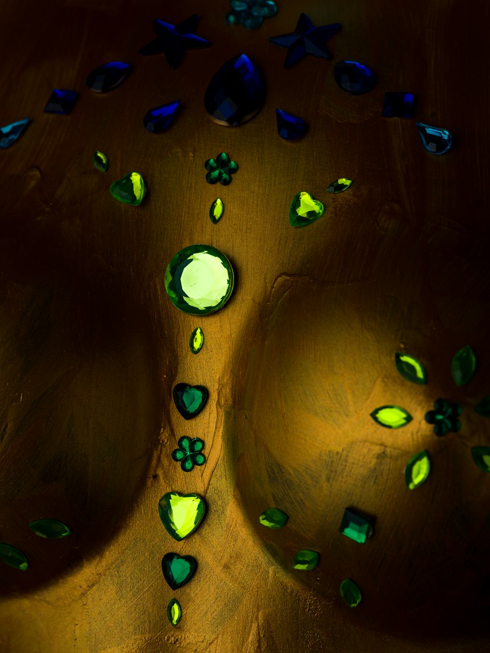 a close up of a sink with green and blue glass