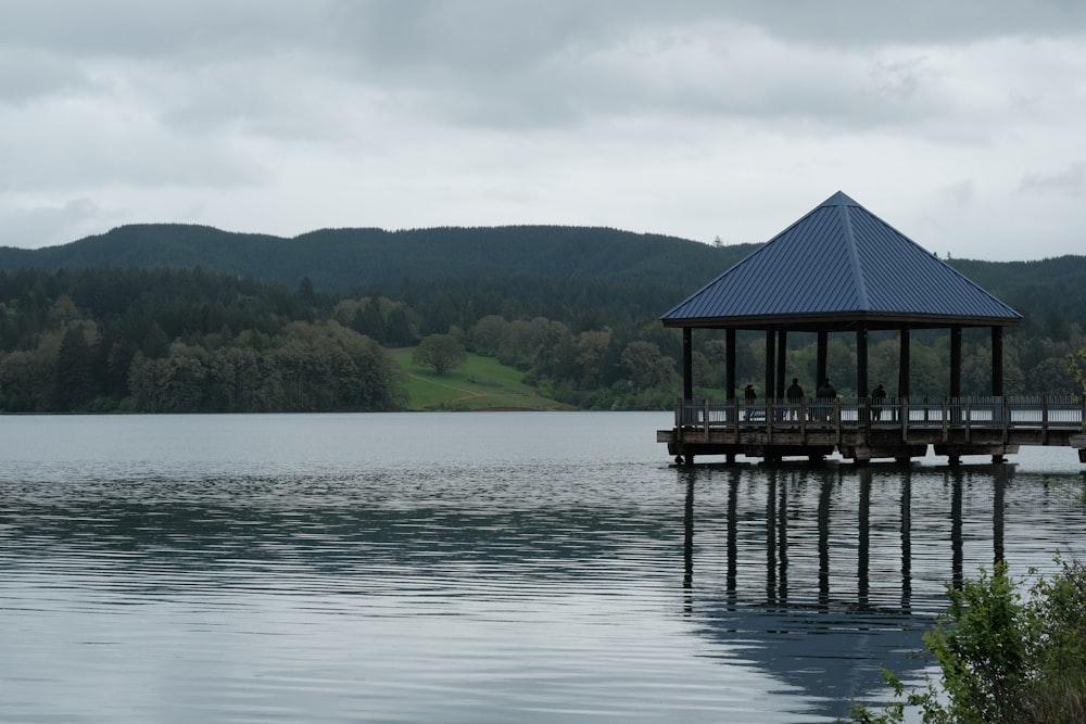 a pier on a lake with mountains in the background