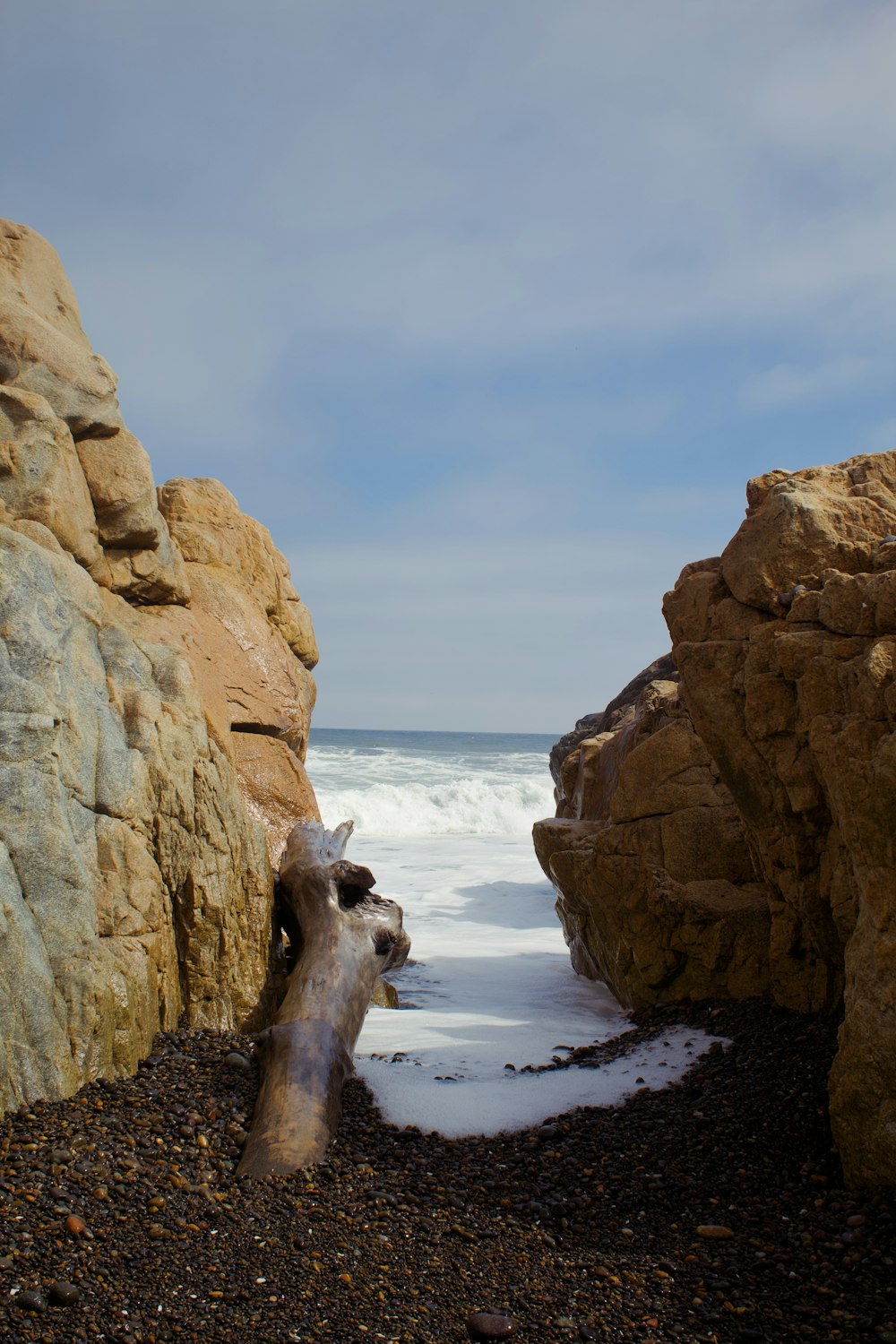 a large rock formation next to a body of water