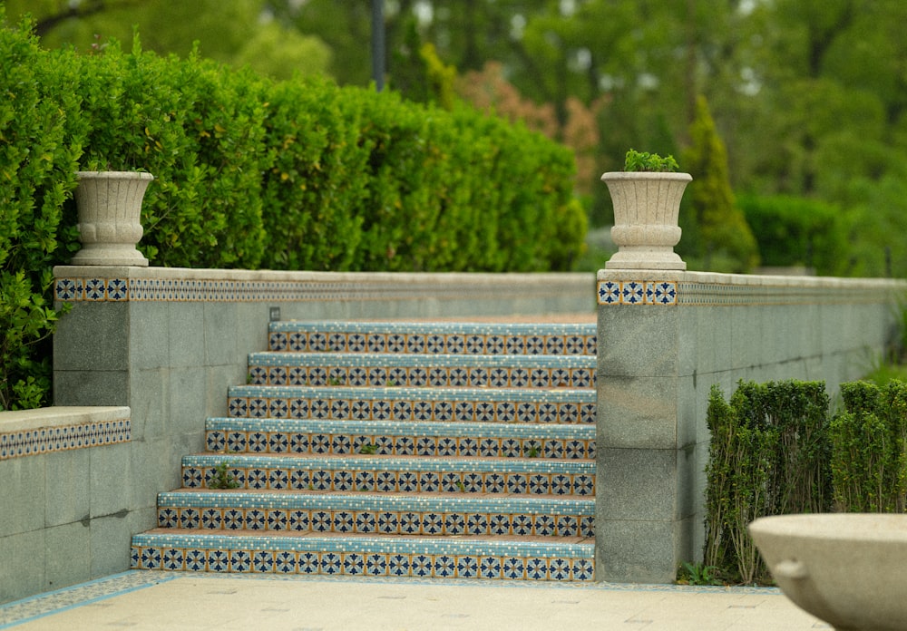 a set of steps with a planter on top of it