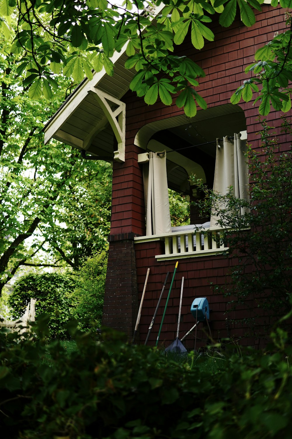 a red brick house with a white porch