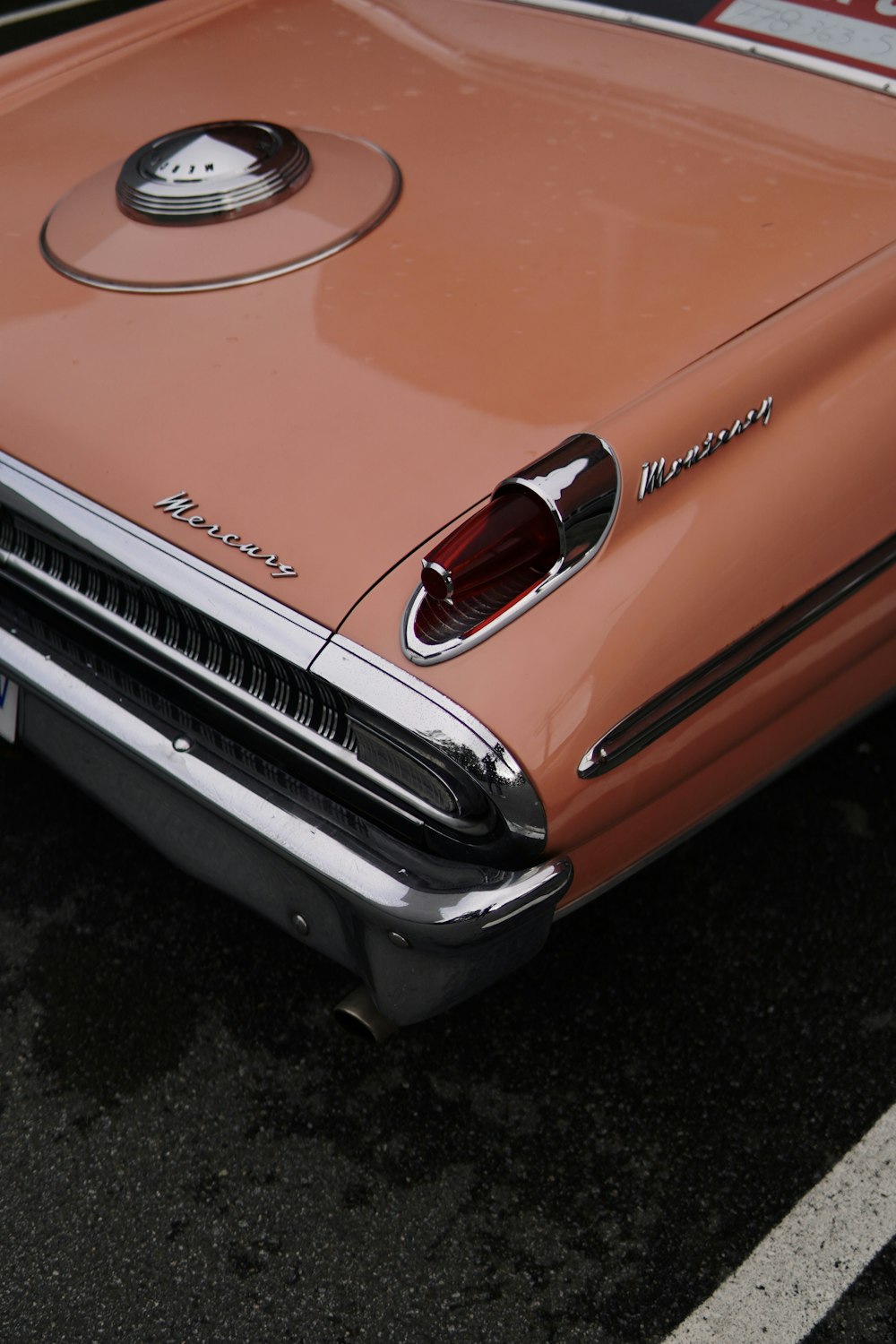 an orange car parked in a parking lot