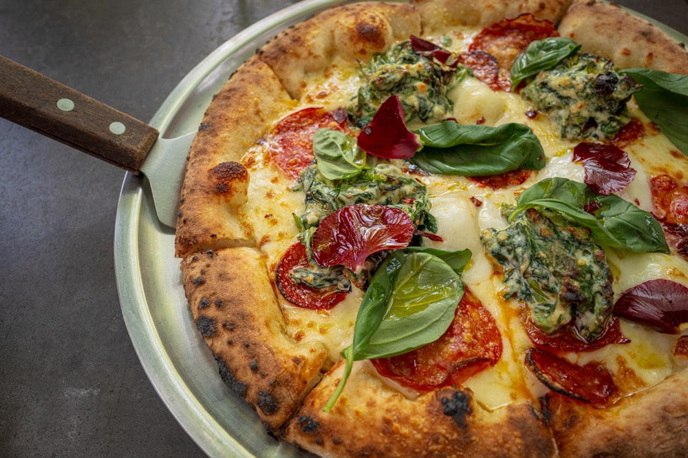 a pizza on a plate with a knife on a table