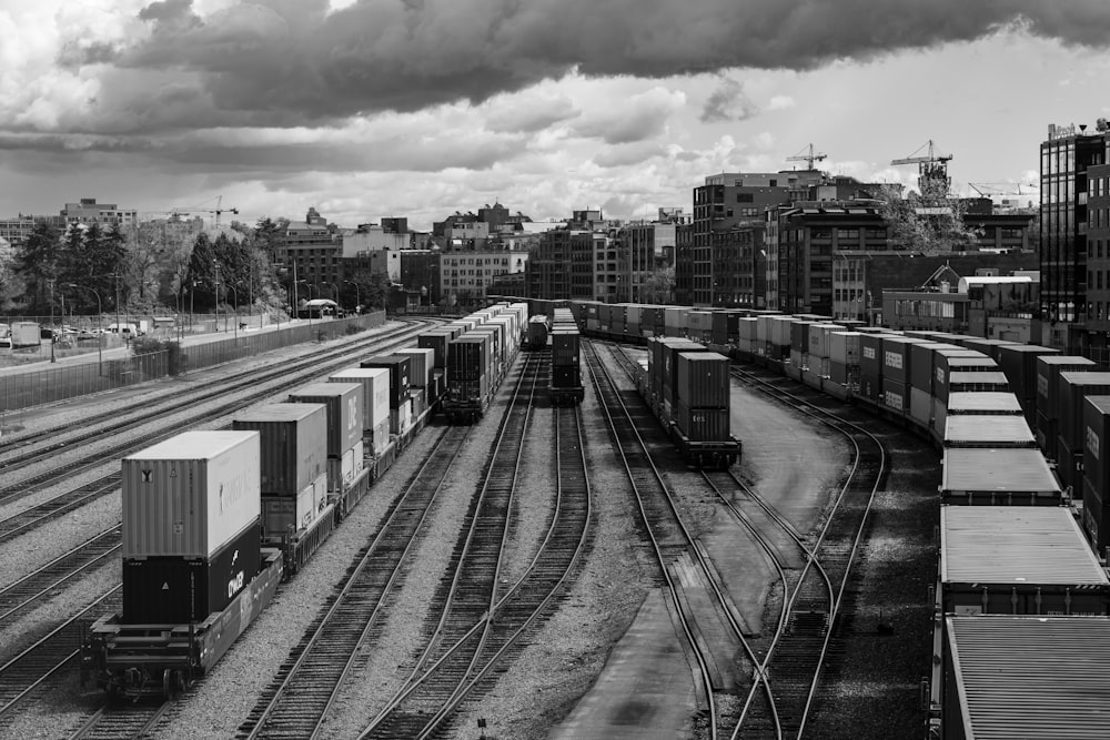 a black and white photo of a train yard