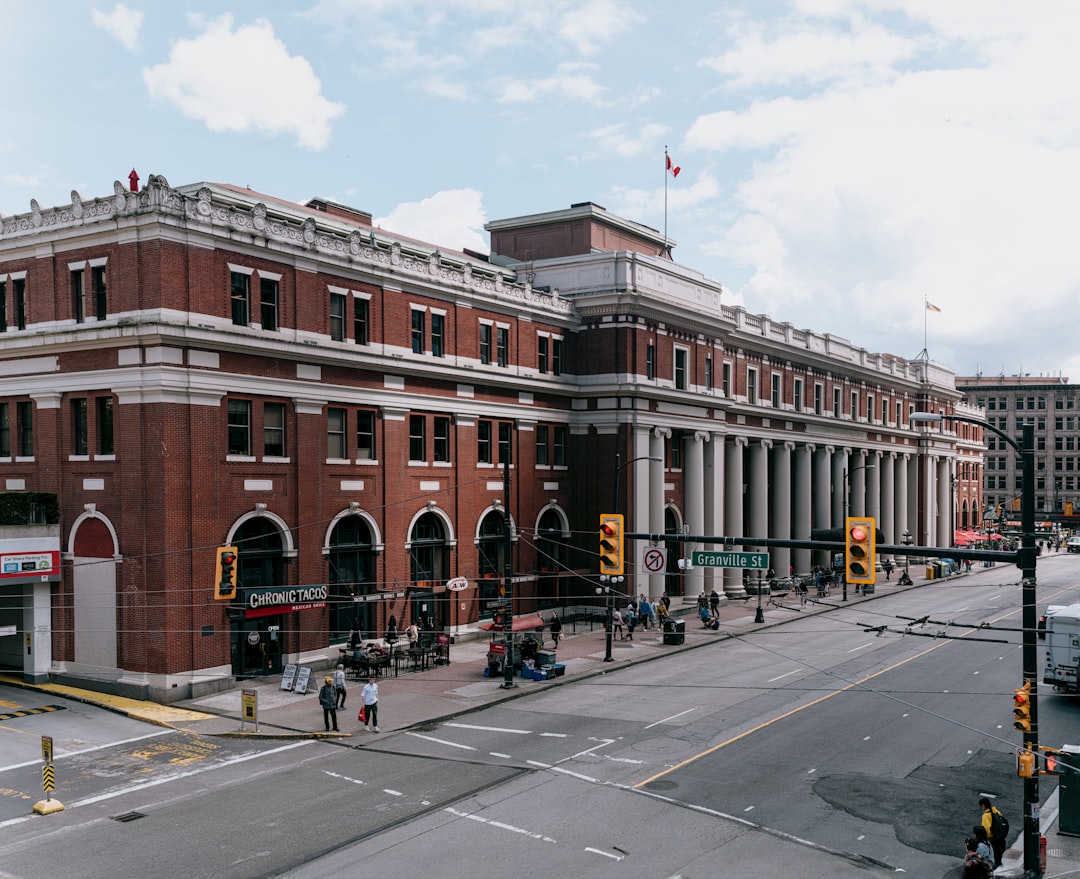 a red brick building on a city street, Waterfront Station in Vancouver