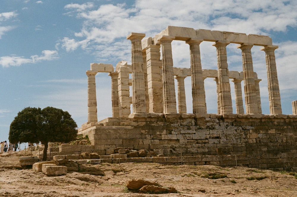 a large stone structure sitting on top of a dirt field