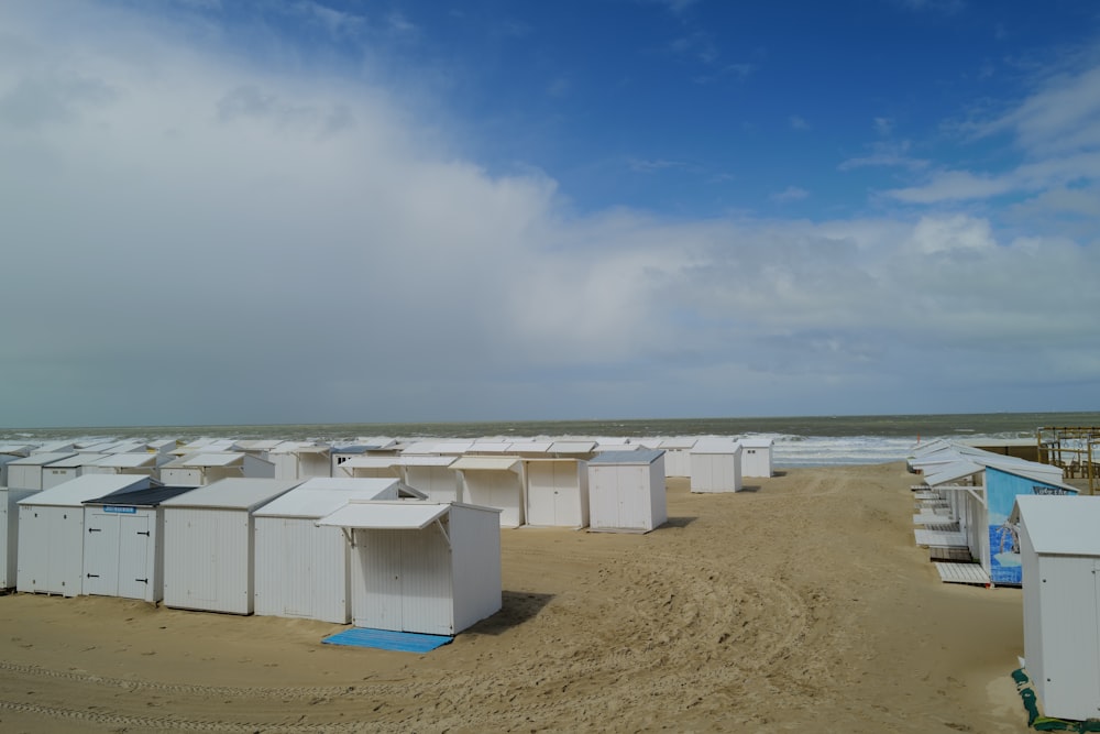 a sandy beach covered in lots of white buildings