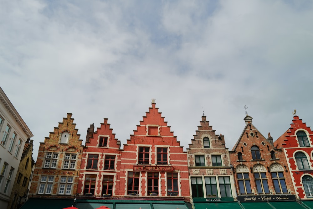 a row of buildings with a red umbrella in front of them