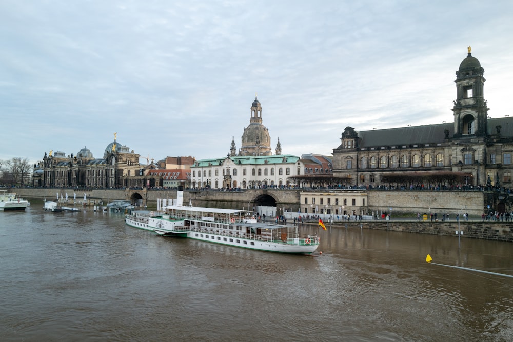 a river with a boat on it and buildings in the background