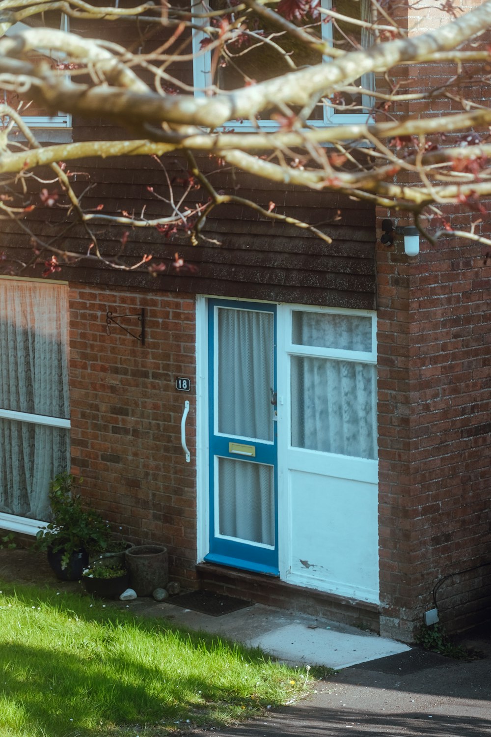 a blue door and window on a brick building