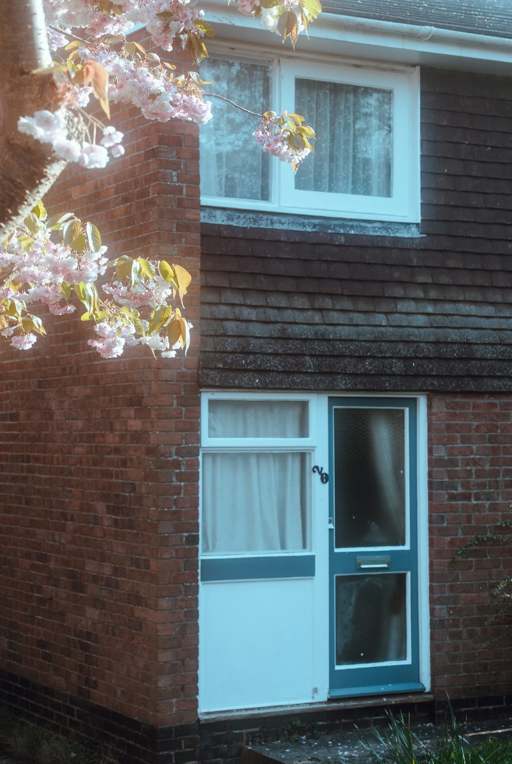 a brick house with a blue door and window