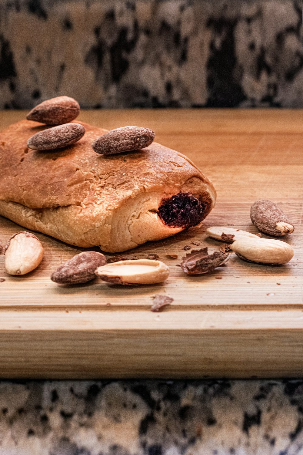 a loaf of bread sitting on top of a wooden cutting board