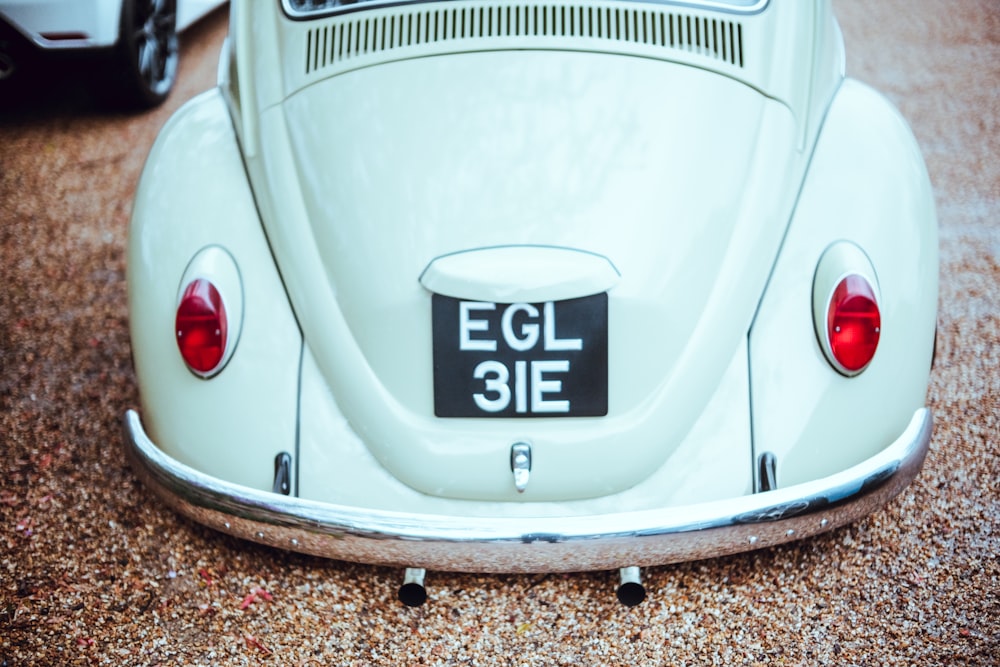 a close up of the back of a white vw bug