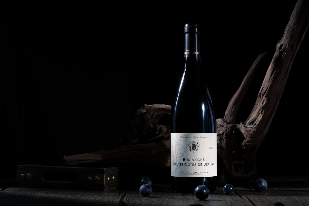 a bottle of wine sitting on top of a wooden table