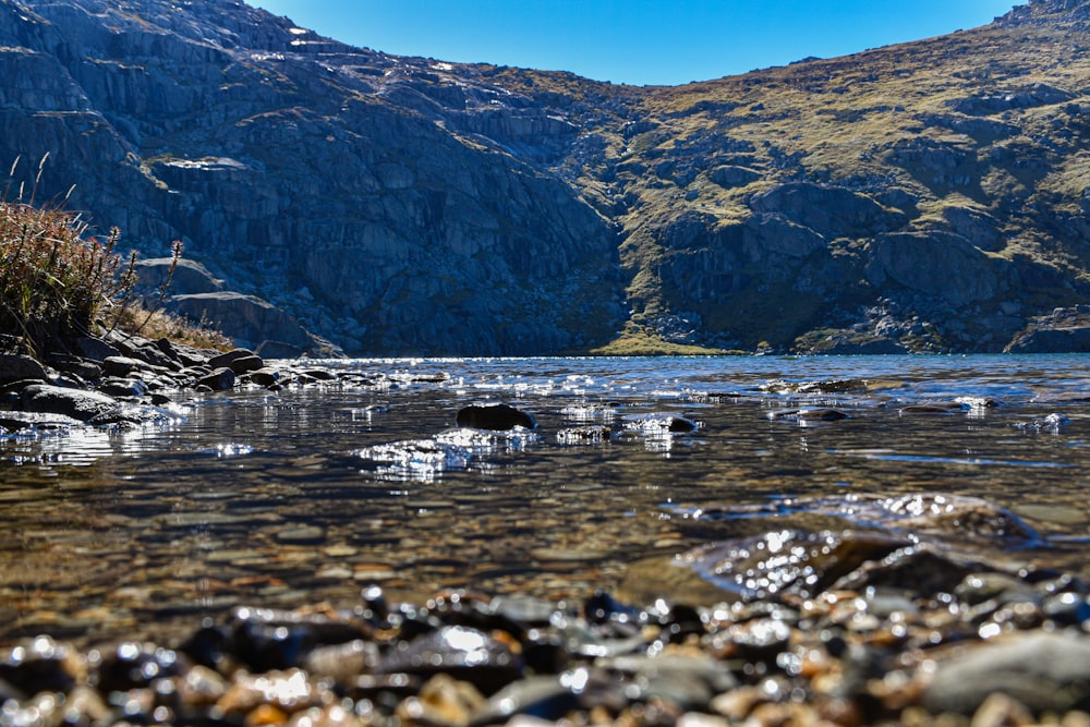 a body of water surrounded by mountains and rocks