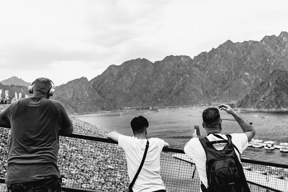 a couple of men standing on top of a tennis court