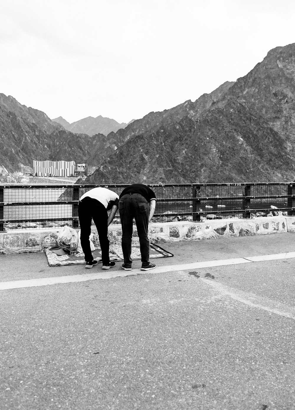 a couple of people standing on the side of a road