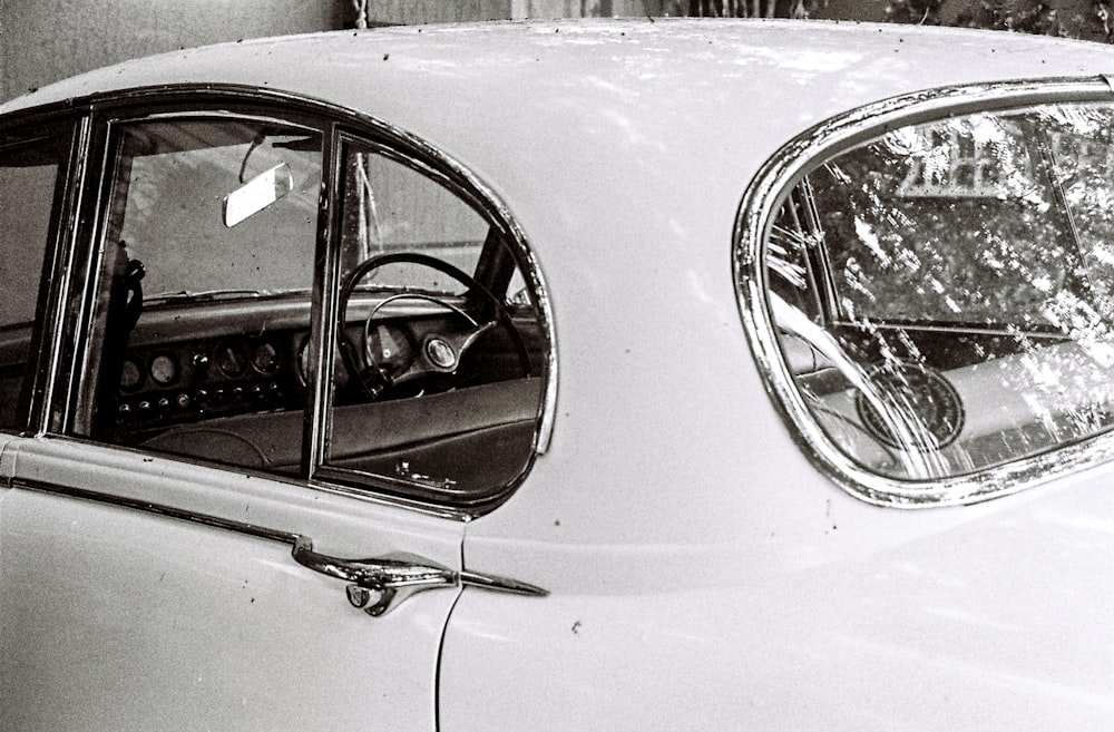 a black and white photo of an old car