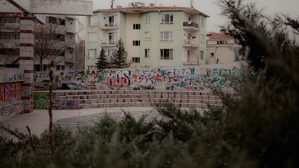 a bunch of graffiti on the side of a building