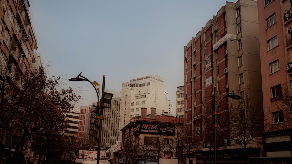 a city street with tall buildings and a street light