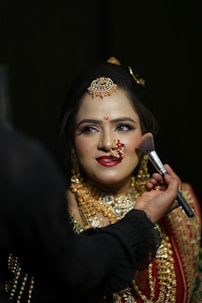 a woman with makeup on her face getting her make - up done