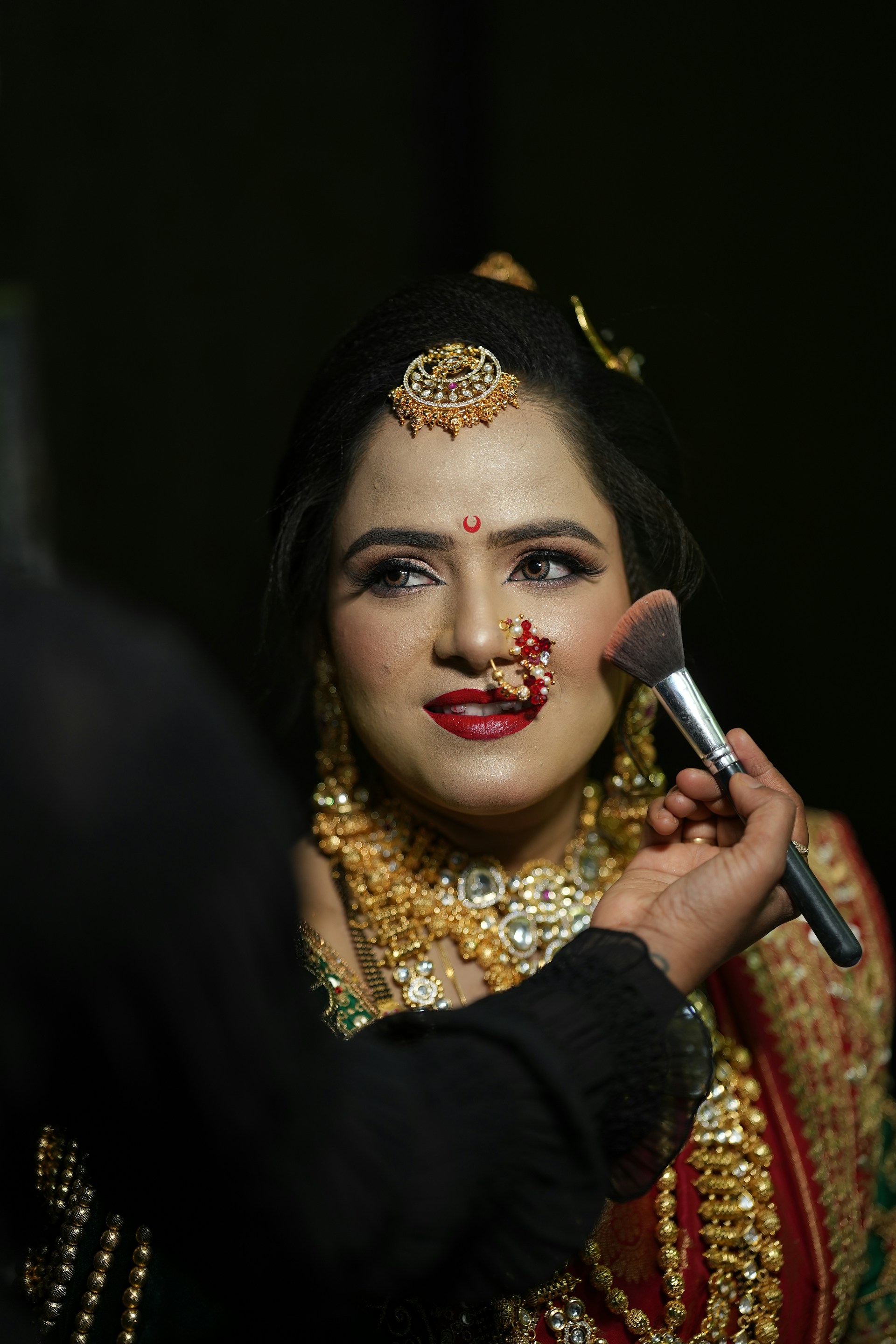 a woman with makeup on her face getting her make - up done
