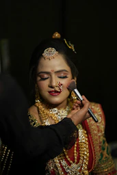 a bride getting her makeup done by a makeup artist