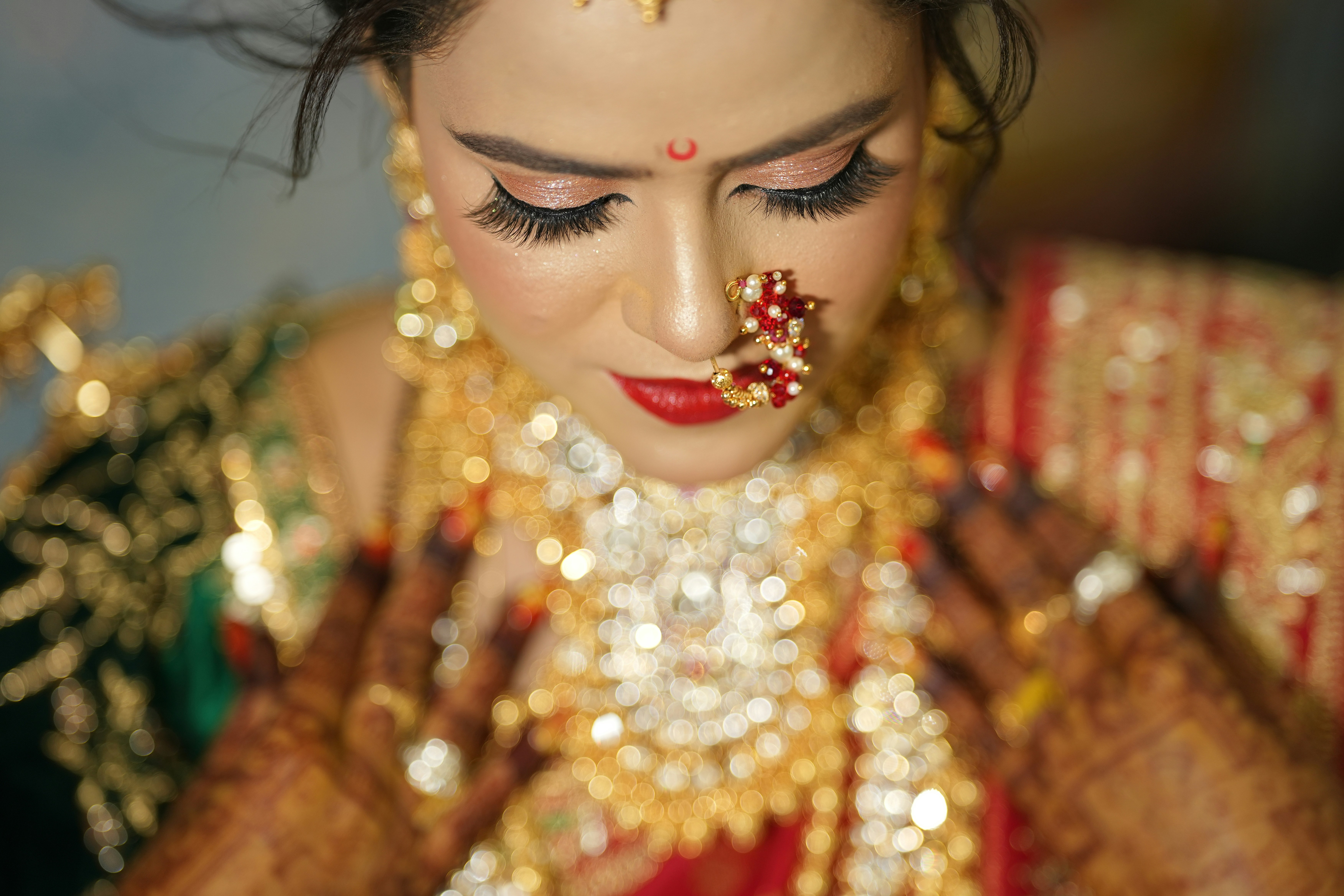 Indian bridal makeup model in gold and red