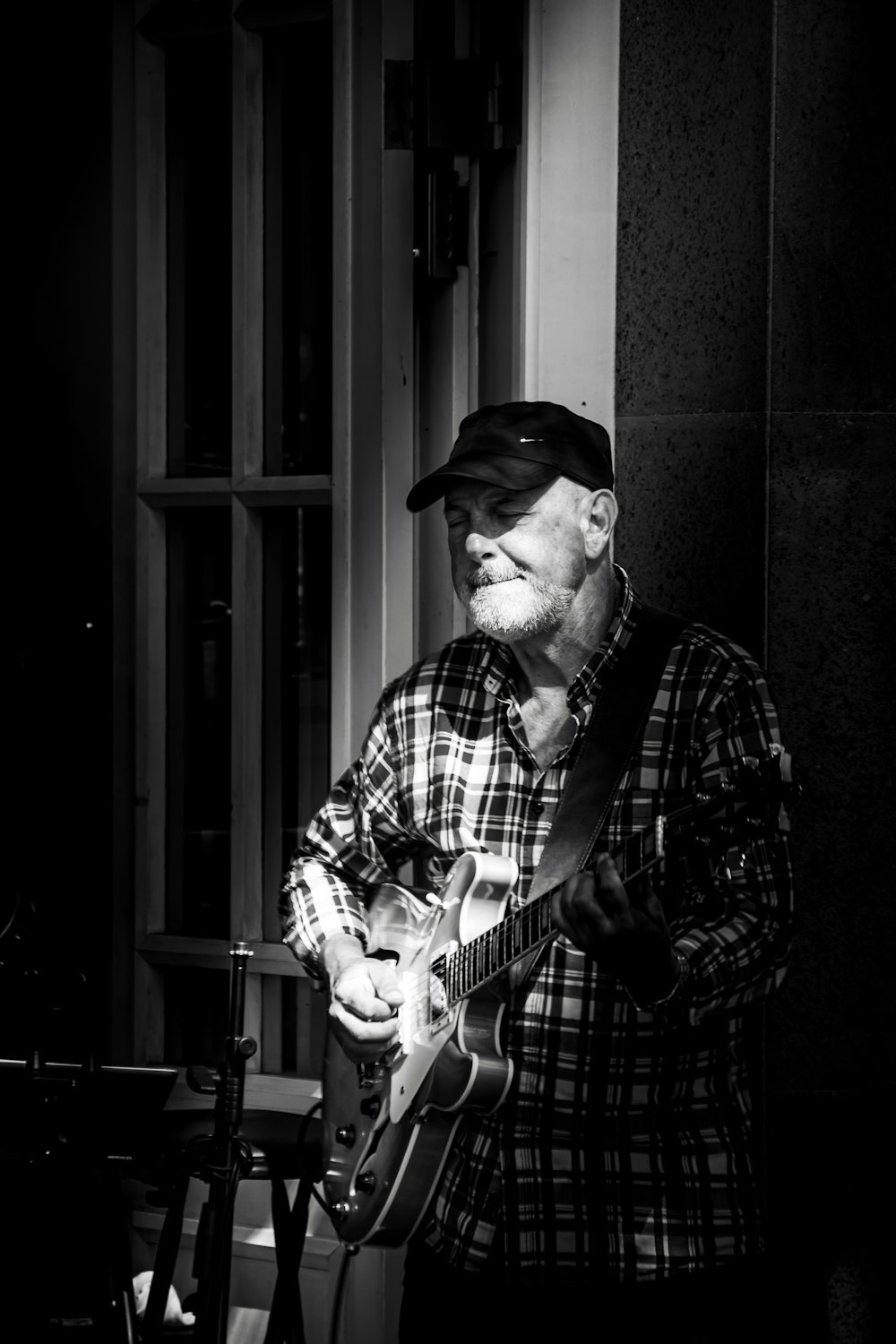 a man playing a guitar in a black and white photo