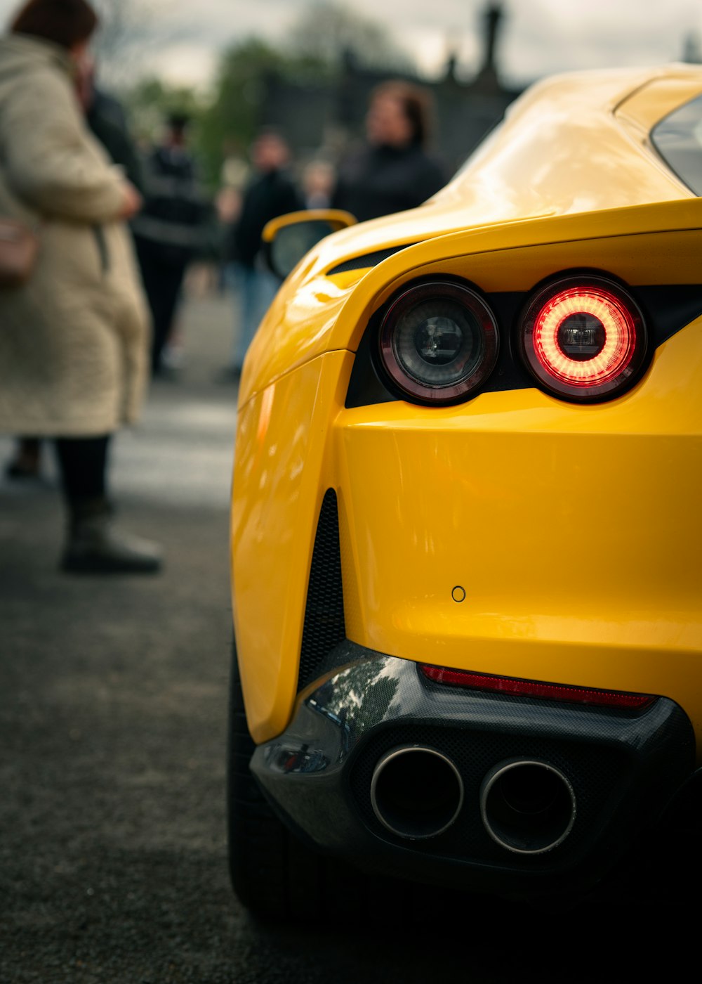 the rear end of a yellow sports car
