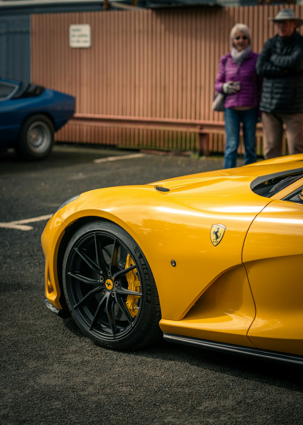 a yellow sports car parked in a parking lot