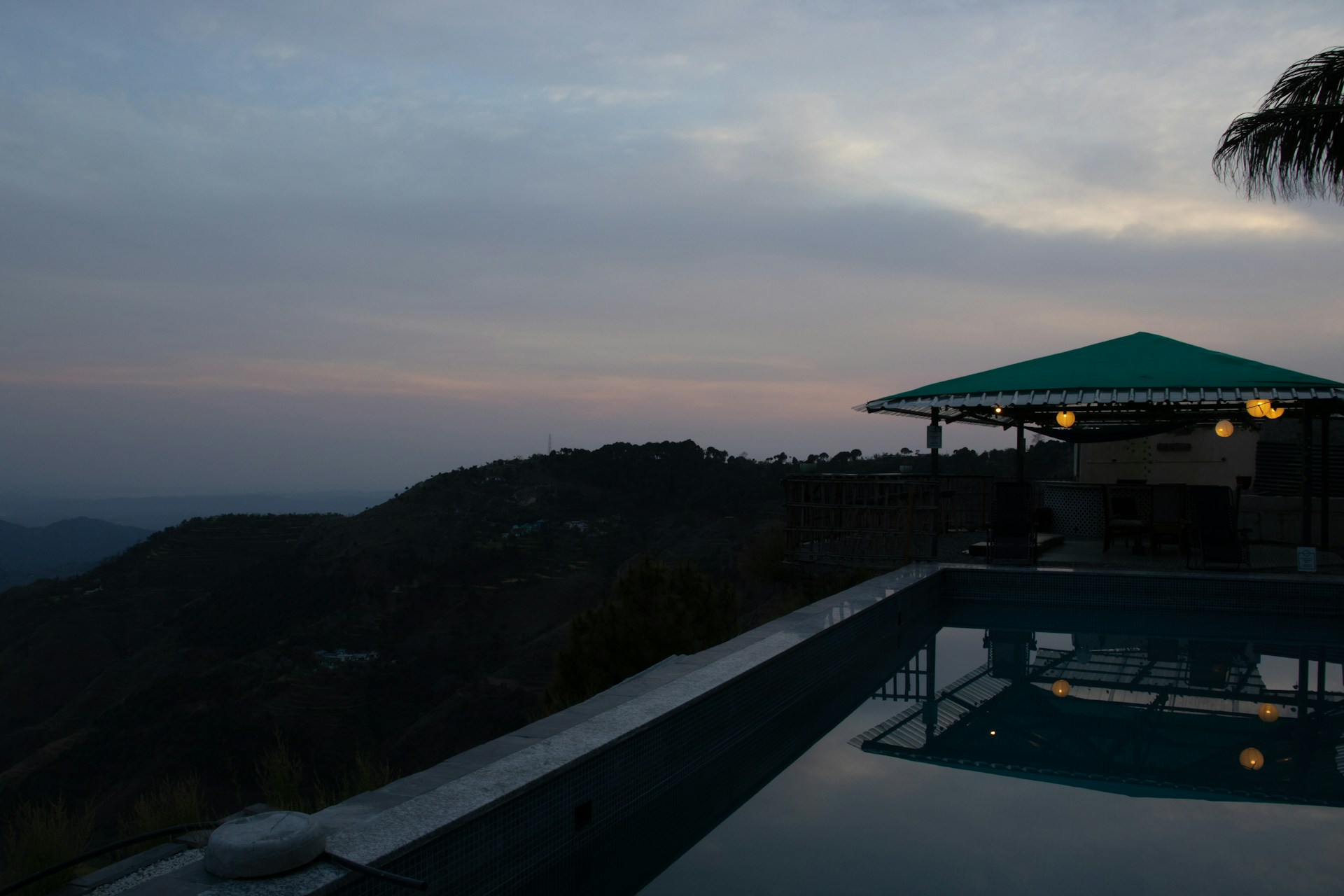 a swimming pool with a gazebo on top of it