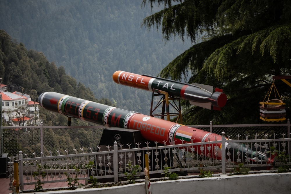 a group of missiles sitting on top of a metal fence