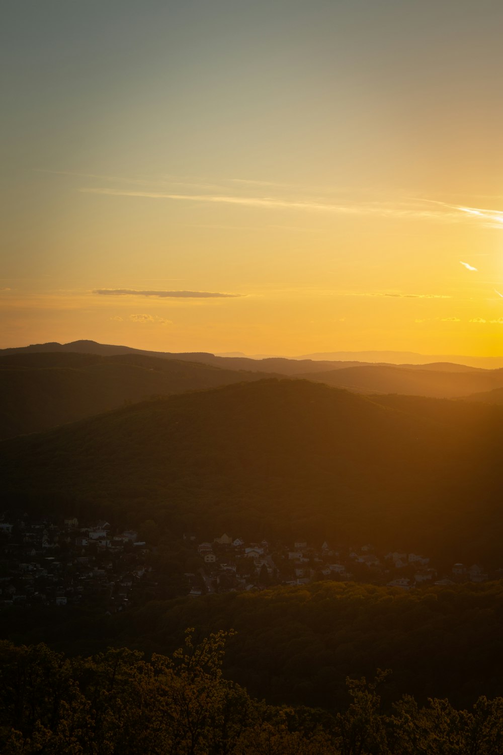 the sun is setting over a mountain range