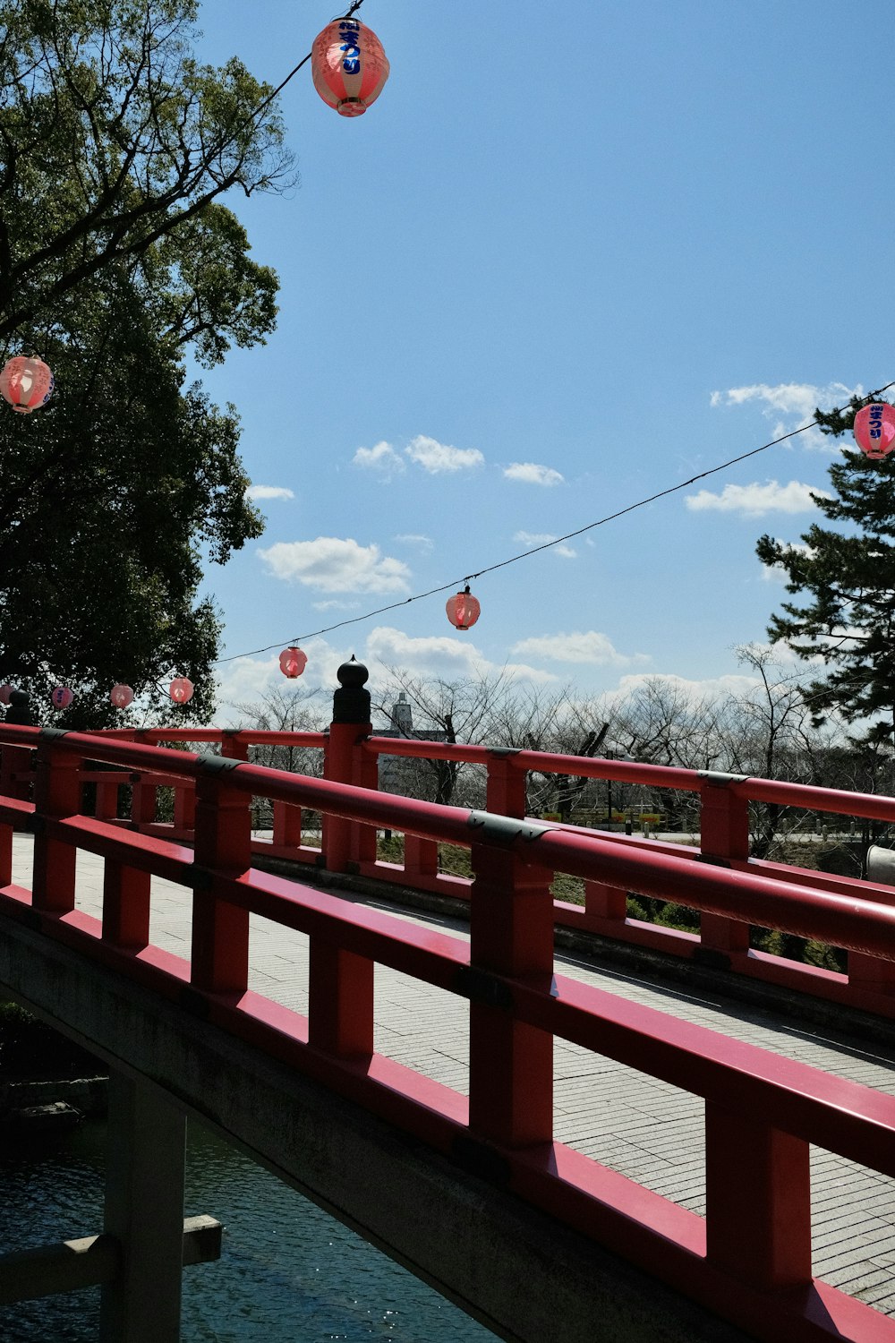 a red bridge over a body of water