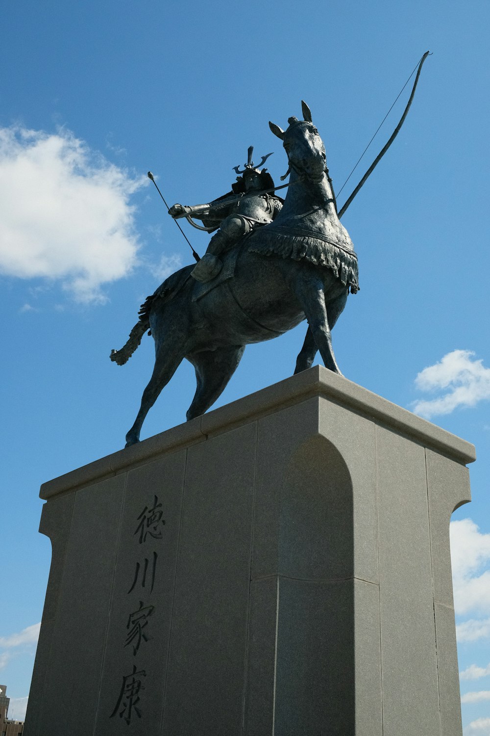 a statue of a man on a horse with a bow