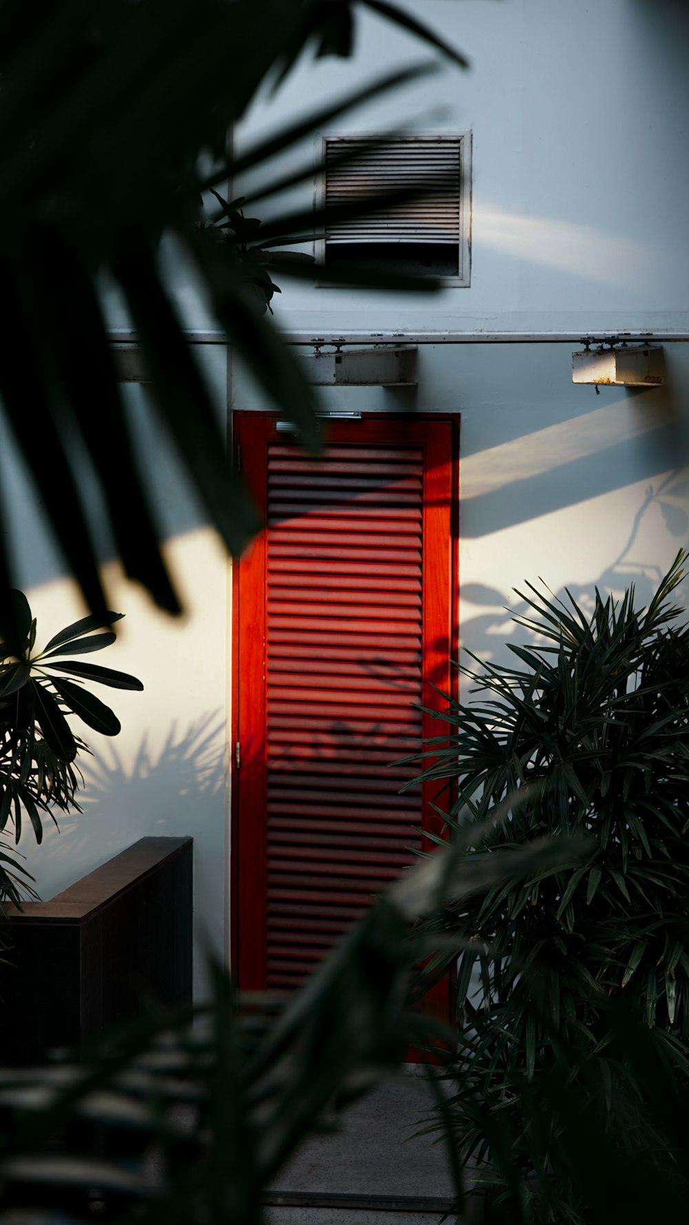 a red door in front of a white building