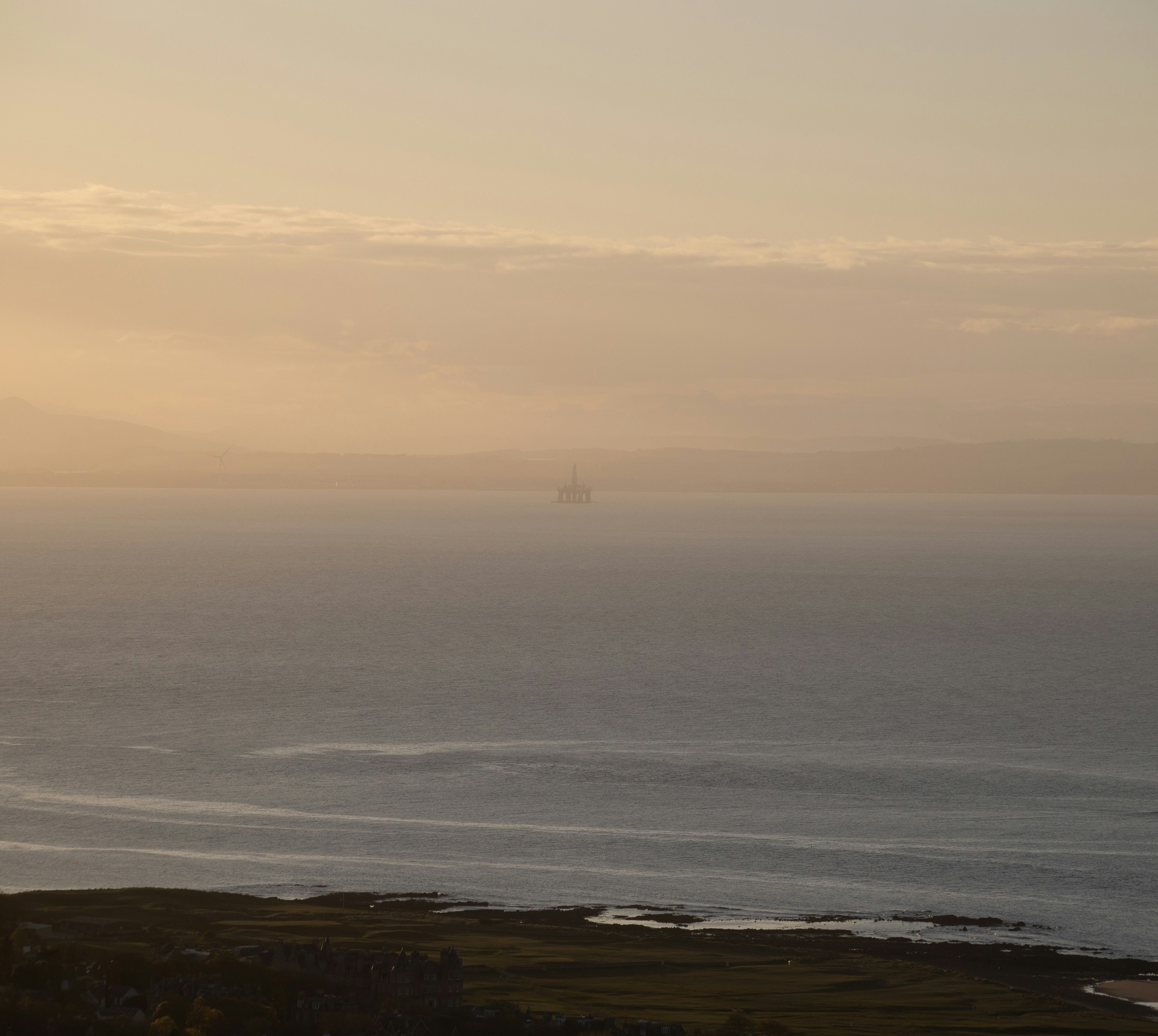 a large body of water sitting under a cloudy sky
