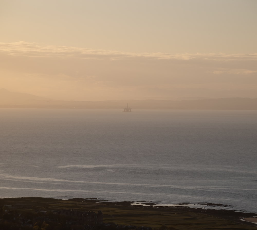 a large body of water sitting under a cloudy sky