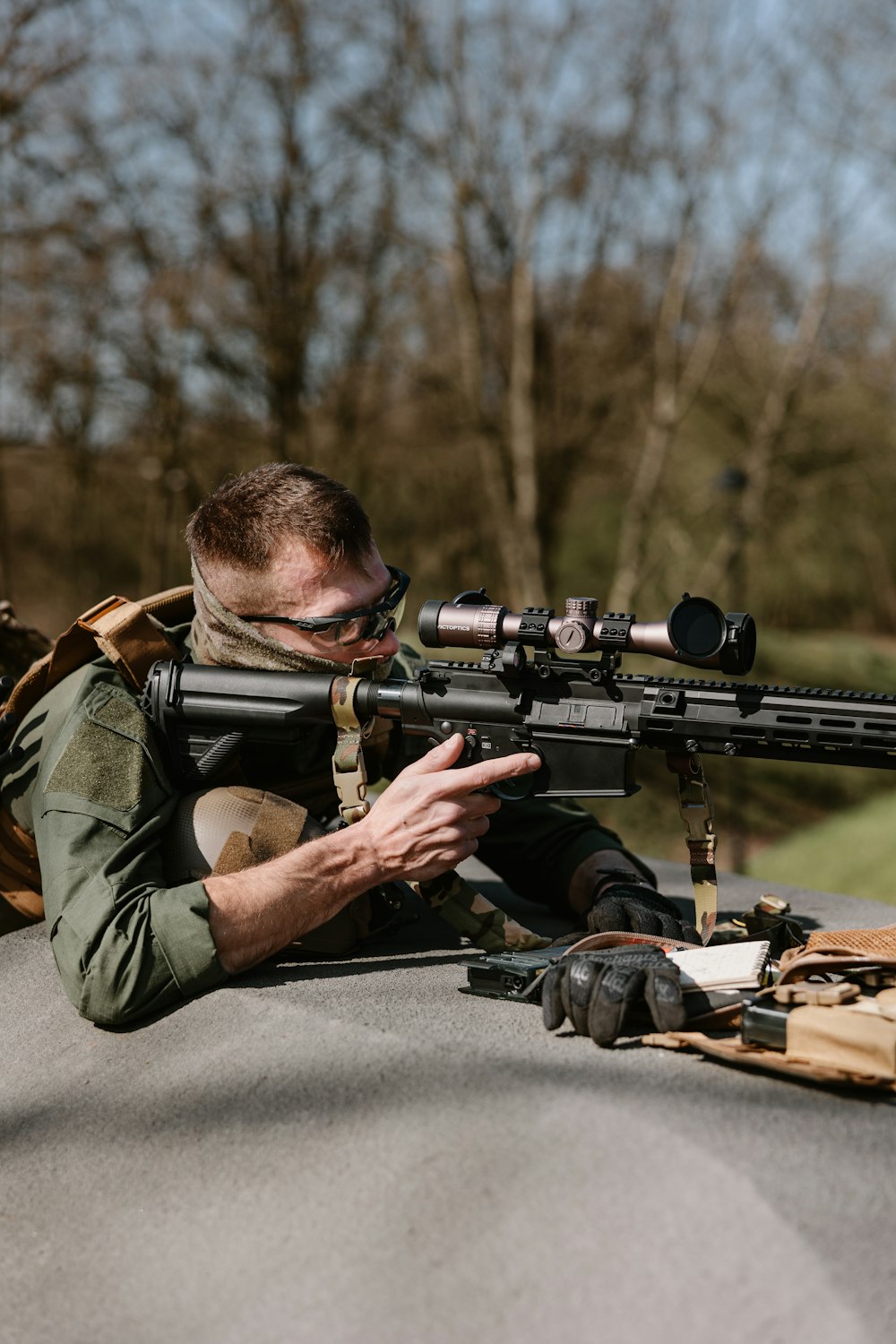 a man with a rifle on a road