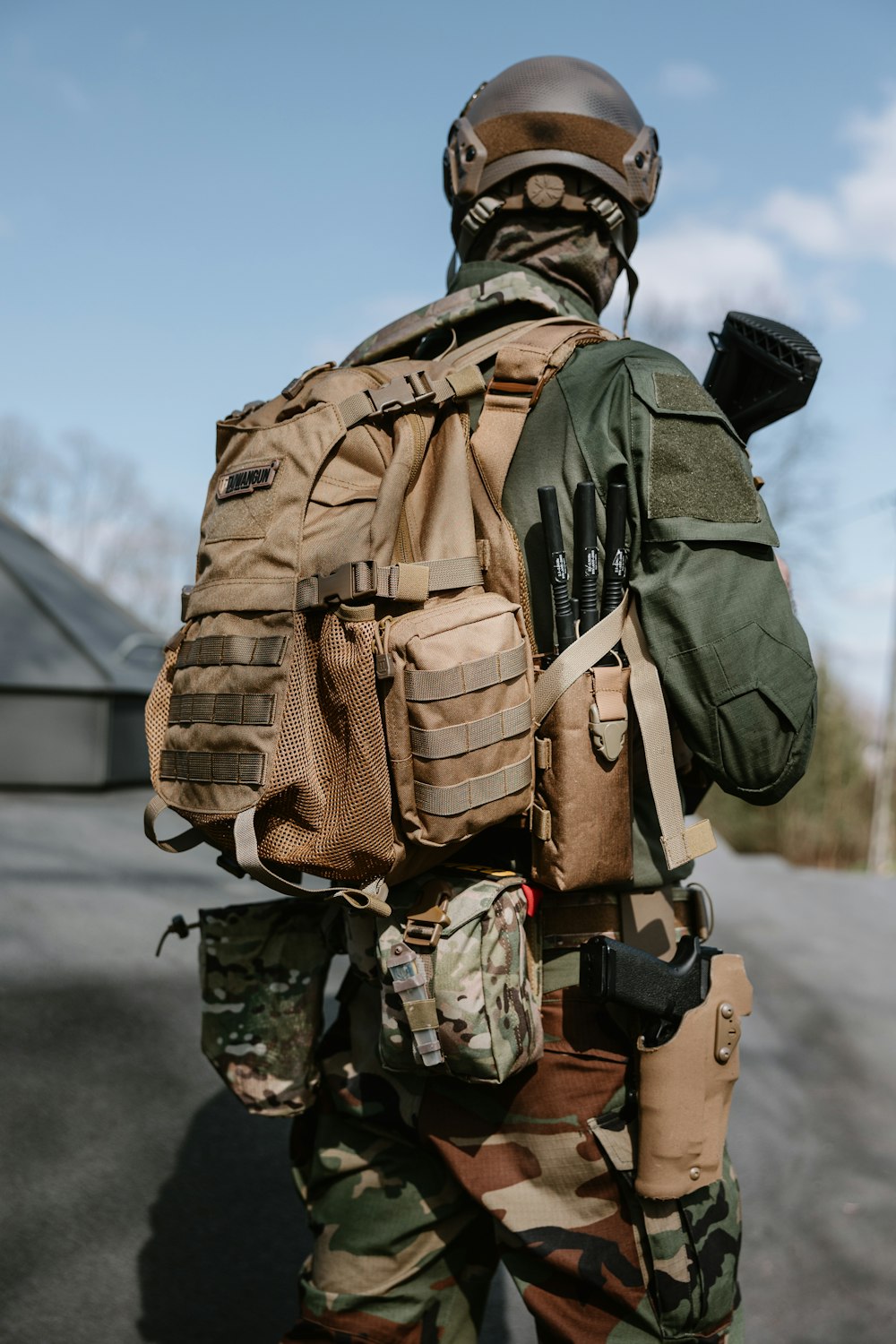 Un hombre camuflado con una mochila a la espalda