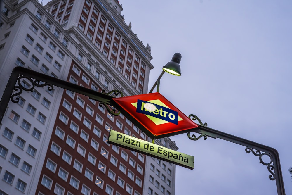 a metro sign hanging off the side of a building