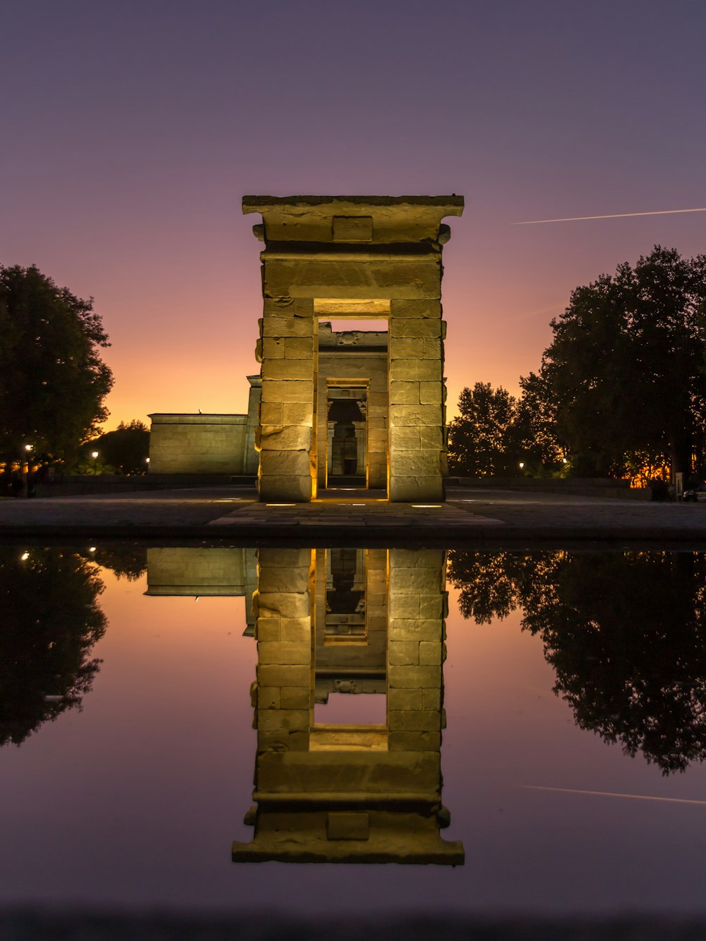 a reflection of a building in a body of water