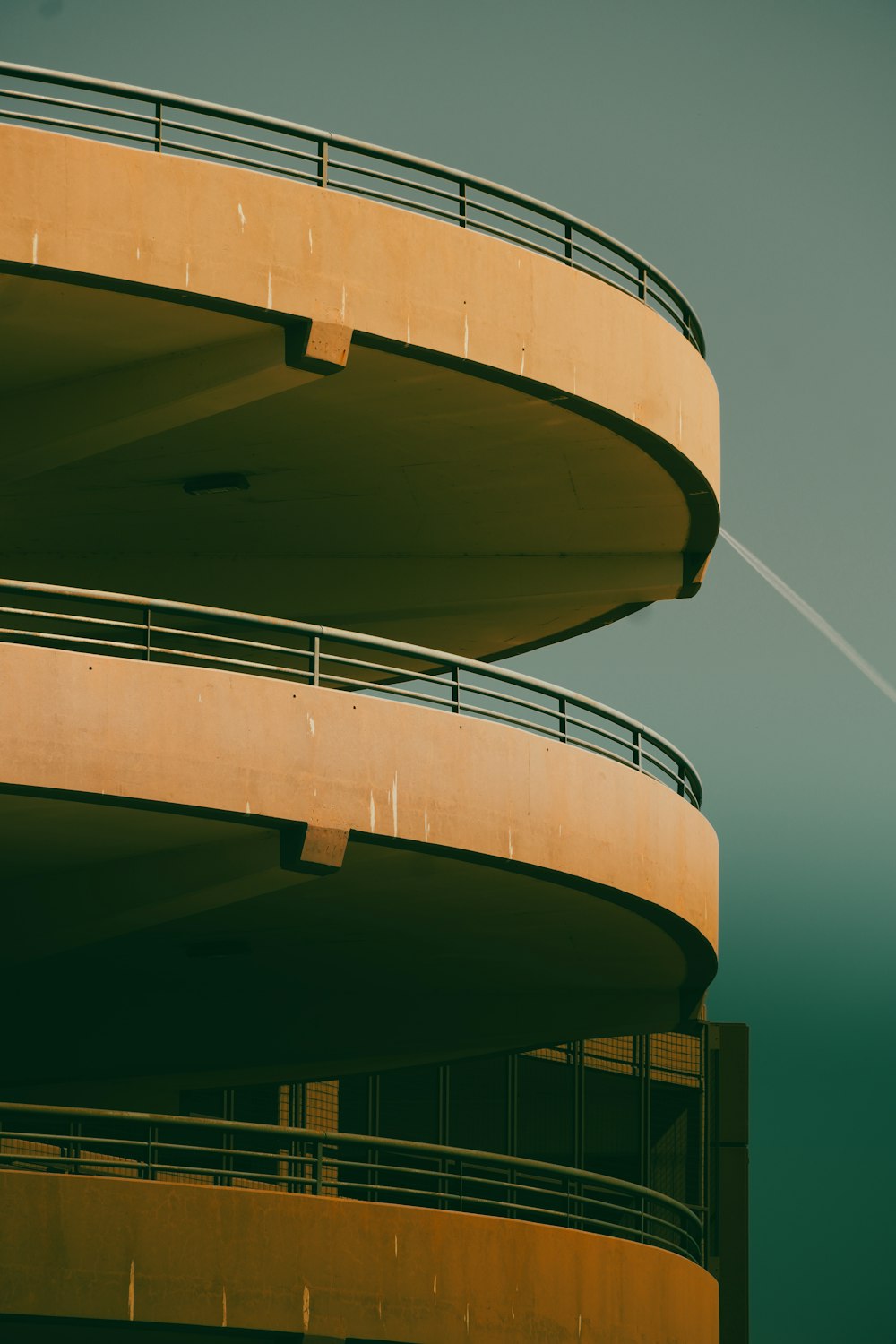 an airplane flying over a building with balconies